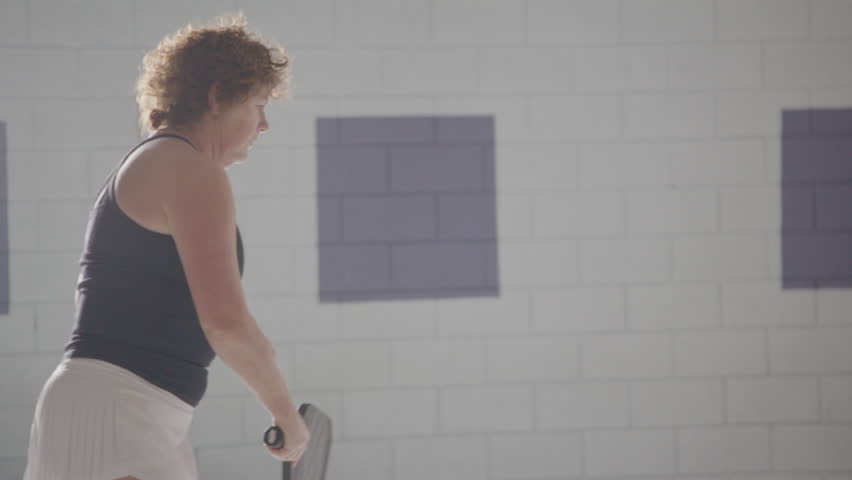 Female active athlete playing pickleball