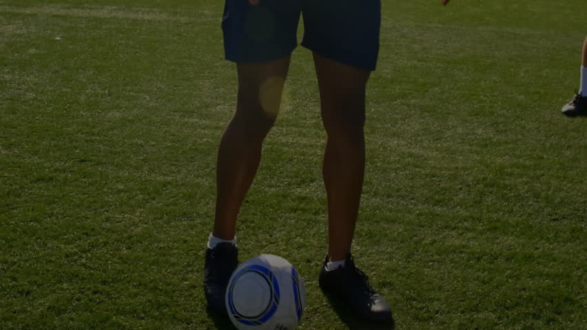 Soccer player tapping ball on turf pitch, revealing animated stock charts showing market trends. Athleticism, finance, technology, sports, digital, competition, performance - Powered by Shutterstock - Get 15% off with code: PIKWIZARD15