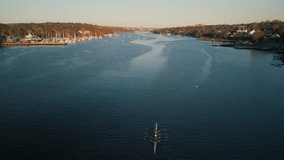 Cinematic drone shot Aerial View Of Rowers In Halifax Bay During Sunrise. The Team Precise Movements Slice Through The Water In Beautiful Coordination Under Soft Morning Light. - Powered by Shutterstock - Get 15% off with code: PIKWIZARD15