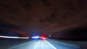 A fast-paced night timelapse of driving along a highway under a dramatic cloudy sky. Bright headlights and blurred taillights create dynamic light trails. Ideal for illustrating late-night travel, spe - Powered by Shutterstock - Get 15% off with code: PIKWIZARD15