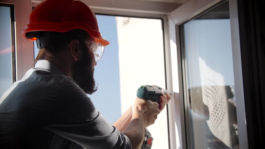 Worker Home Repair With Tools. Windows Frame Replace. Apartments Renovation. Repairman House Renovation. Master Home Restoration And Reconstruction. Experienced Repairman Installing Plastic Windows.