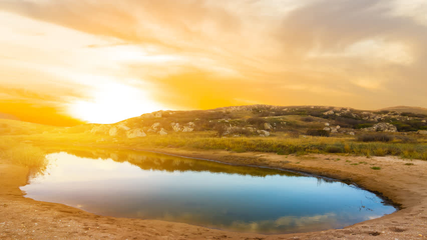dramatic sunset over a small prairie lake time lapse scene