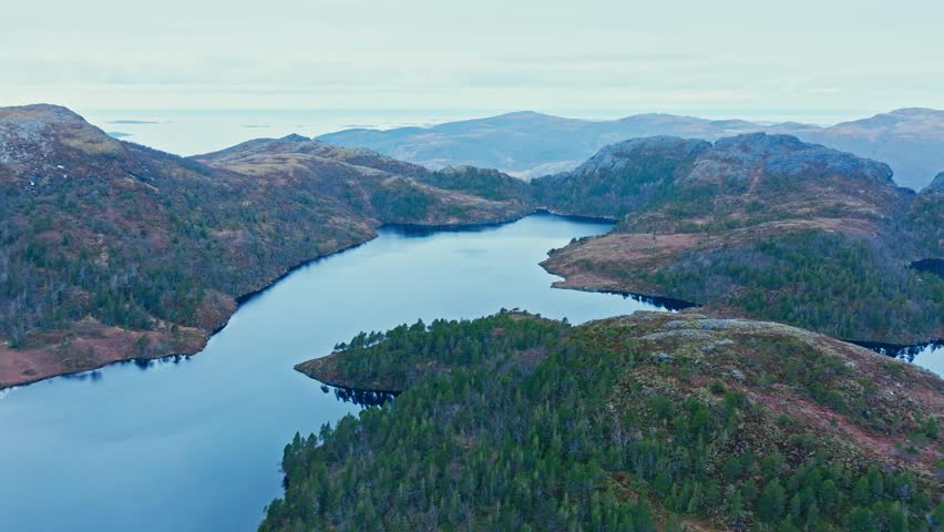 Serene Kattavatnet Lake Through Rugged Hilly Terrain In Norway. aerial shot