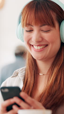Girl, relax and laughing on smartphone with headphones on couch for streaming funny videos on blog website. House, meme or happy woman with online subscription for podcast and comedy post on break