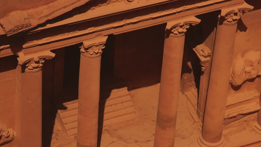 Close-up view of the carved sandstone facade and columns of the ancient Treasury building at Petra, Jordan.