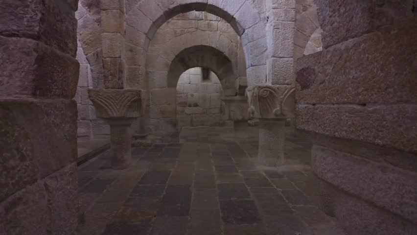 Horizontal footage panning from the stone floor to the ceiling, revealing the Romanesque arches of the central nave in the crypt of Leyre Monastery, Spain.  - Powered by Shutterstock - Get 15% off with code: PIKWIZARD15