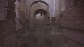 Horizontal footage panning from the stone floor to the ceiling, revealing the Romanesque arches of the central nave in the crypt of Leyre Monastery, Spain.  - Powered by Shutterstock - Get 15% off with code: PIKWIZARD15