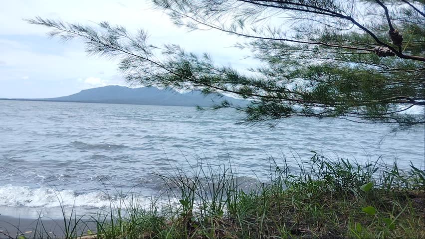 Feeling the waves at Cacalan Beach and see the mountains in Bali from Banyuwangi 