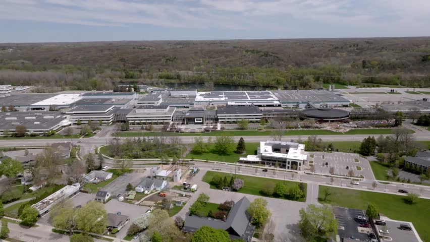Amway North American Headquarters building in Ada, Michigan with drone video moving left to right.