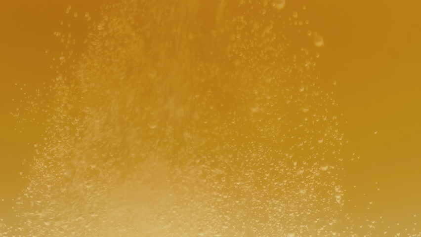 Slow motion macro shot beer pouring into a glass. Beautiful Beer Bubbles Rising Up. Loopable Animation of Sparkling Water. Video 4K