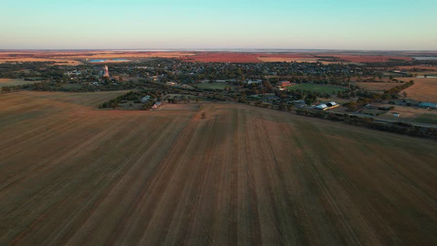 An aerial fly towards the small country town of Sea Lake at sunrise in Victoria, Australia