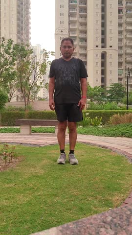 Corporate executive doing exercise in the garden, urban lifestyle.