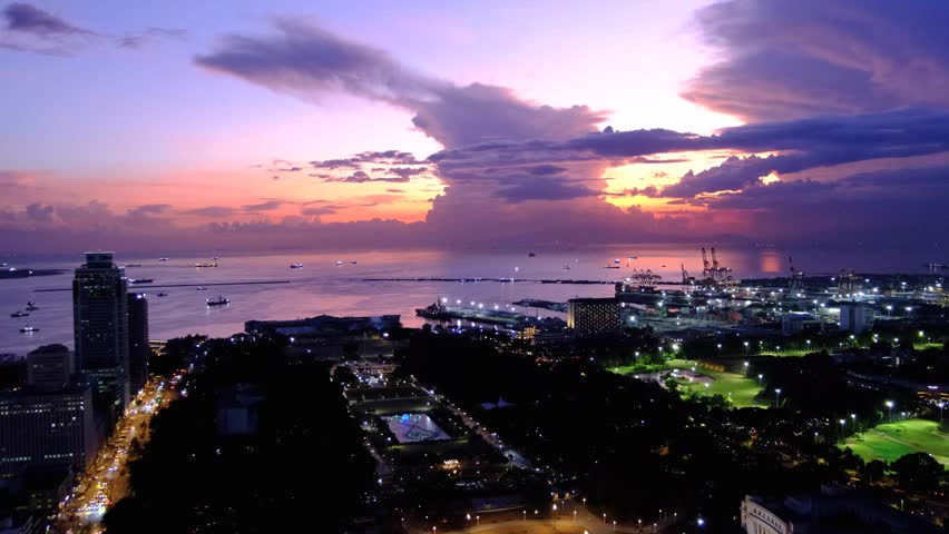 Static aerial view overlooking Rizal Luneta Park during stunning sunset in capital city of Manila Philippines