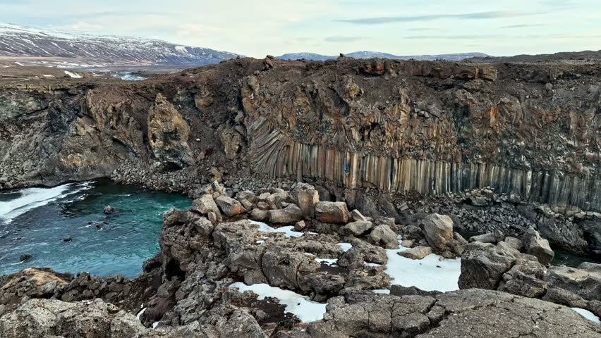 Drone moving over stones, toward the Aldeyjarfoss river, spring day in Iceland