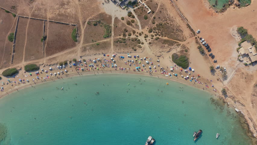 Wide aerial establishing of Pori Beach coastline curving along calm Cyclades island water, Greece