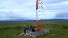 Telecommunication Tower with Solar Panels in Rural Africa: Connectivity and Renewable Energy in Nature. - Powered by Shutterstock - Get 15% off with code: PIKWIZARD15