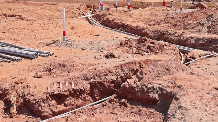 Worker are excavating land for utility installation at construction site