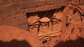 High angle view looking down at the ancient Treasury building facade carved into the sandstone rock walls in Petra, Jordan. - Powered by Shutterstock - Get 15% off with code: PIKWIZARD15