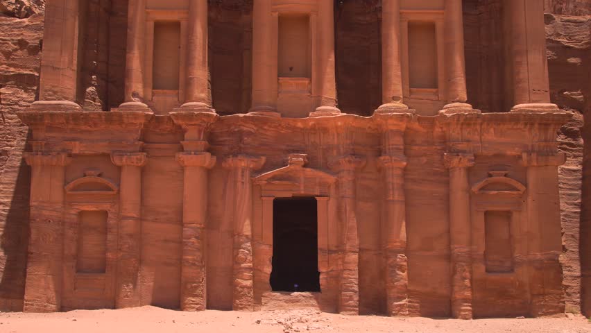 Rock-cut facade of the ancient Monastery (Ad Deir) carved into sandstone cliffs in Petra, Jordan.