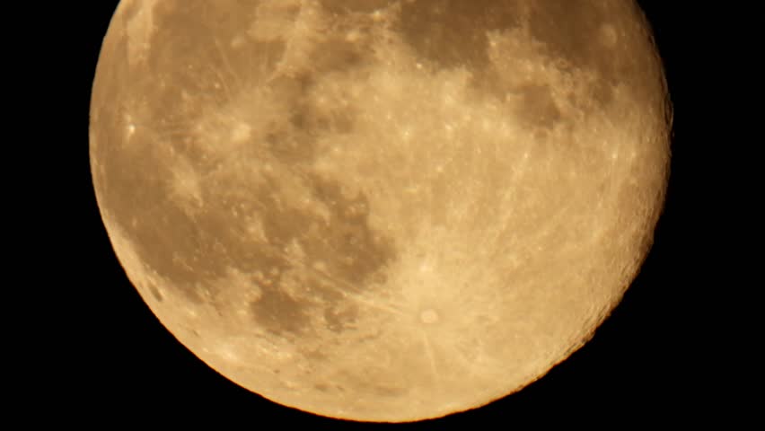 Full moon close up. Yellow moon in the night sky. Bright full moon photo.