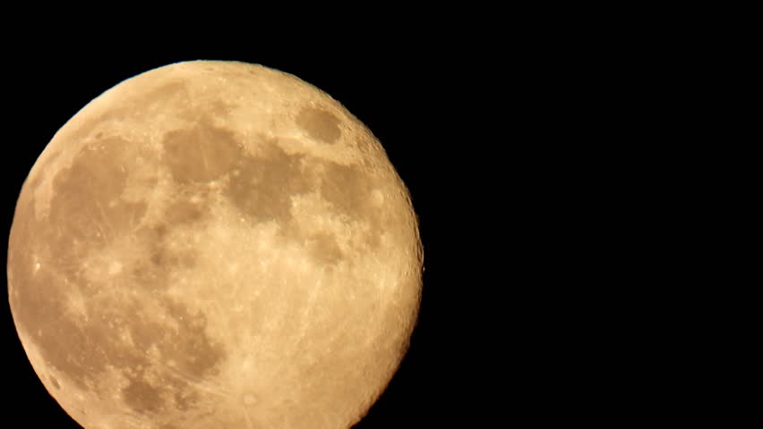 Full moon close up. Yellow moon in the night sky. Bright full moon photo.