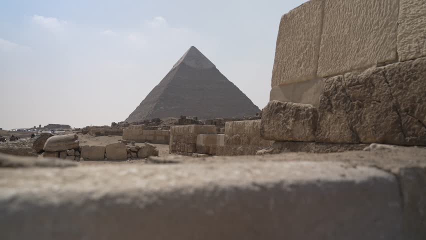 View of the Khafre Pyramid of Giza with passing horse and carriages on a sunny day, Giza, Cairo, Egypt, Africa