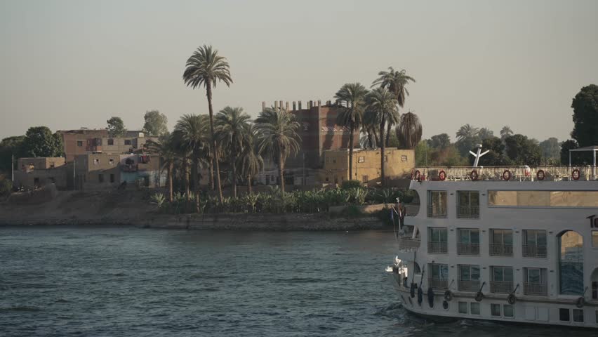 View of scenery and cruise boats from a cruise boat sailing on the Nile River between Luxor and Edfu on sunny day, Luxor, Egypt, Africa