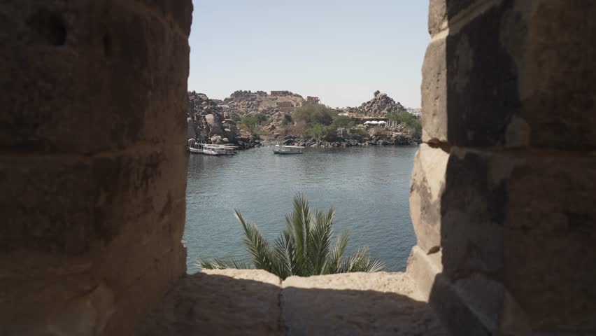 View of boats on the River Nile from Philae Temple on a sunny day, Philae Temple, Aswan, Egypt, Africa