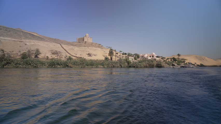 View of Aga Khan Mausoleum from small boat on the Nile in daytime, Aswan, Egypt, North Africa, Africa