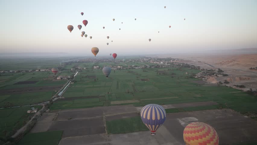 View of hot air balloons over Luxor and Nile river at sunrise, Luxor, Egypt, North Africa, Africa