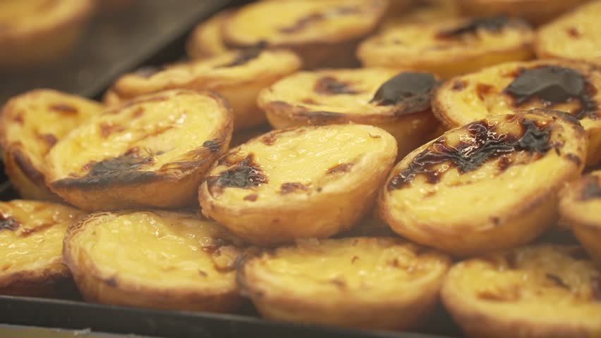 Close up of pastel de nata, Portuguese custard tarts, in bakers shop window, Lisbon, Portugal, Europe