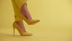 Yellow high heels on yellow background video in HD - Powered by Shutterstock - Get 15% off with code: PIKWIZARD15