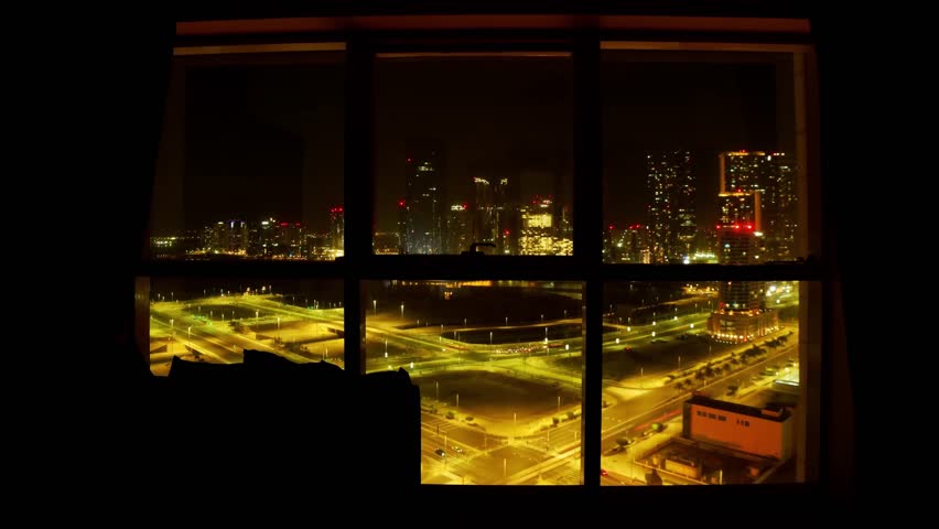 High-Rise new building Bedroom Window View Abu Dhabi Cityscape with Traffic Below at night. Safety business promo banner vertical copy background cityscape modern apartments mortgage rentals concept