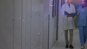 Doctor and nurse walking hospital corridor reading chart activating digital overlays mapping data. Medical professionals, healthcare, technology, digital interface, clinical, teamwork, diagnostics - Powered by Shutterstock - Get 15% off with code: PIKWIZARD15