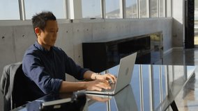 Mature man typing on laptop at office desk causing translucent user icons expanding digital network. Technology, digital, connectivity, innovation, workspace, modern, communication - Powered by Shutterstock - Get 15% off with code: PIKWIZARD15