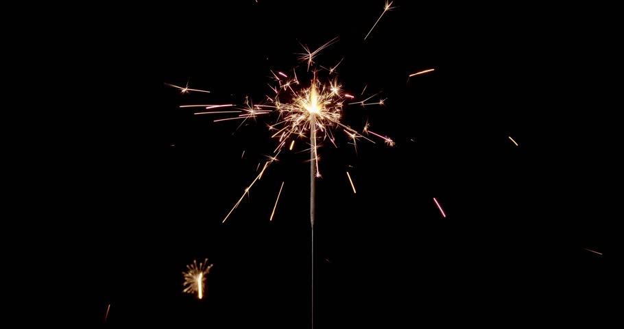 Lightening sparkler on the black background. Sparkler concept. Bengal lights are burning on a black background. Holiday party concept. New year party sparkler. Slow motion.