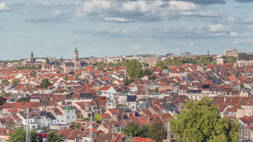 Aerial timelapse panorama over Brussels skyline in Schaerbeek near the railway station. Residential blocks, Saint-Servais Church and Town Hall surrounded by red rooftops in Belgium