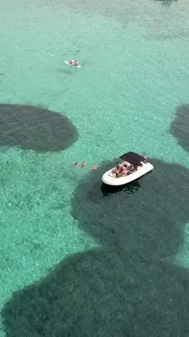 Brac Island in Croatia. Bol town in aerial view, vertical video.