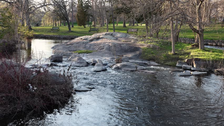 City park with a stream in spring. Stewart Park In Perth, Ontario, Canada.