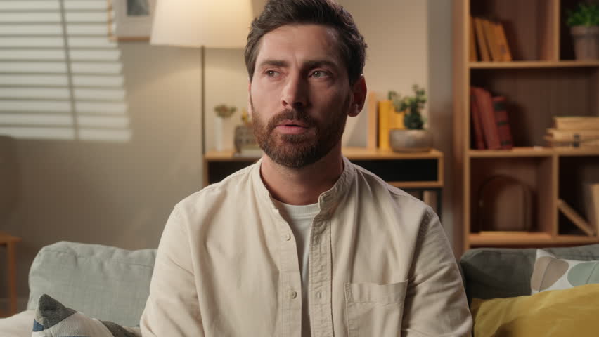 Caucasian man thoughtful pensive guy at home think alone male homeowner tenant smart businessman pondering dreaming domestic weekend choosing planning idea remember dream brainstorm cognition smile