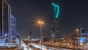 Panoramic aerial night timelapse of Riyadh featuring highway traffic, Kingdom Tower the tallest skyscraper and landmark of Saudi Arabia's capital. Illuminated modern buildings surround vibrant scene - Powered by Shutterstock - Get 15% off with code: PIKWIZARD15