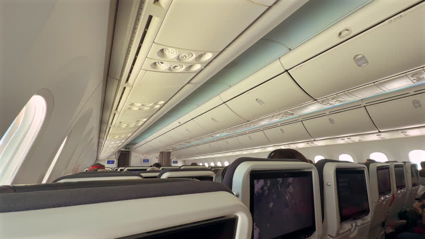 An airplane from the inside with seats, aircraft flight, cabin on an airplane, airline travel, commercial aviation with windows and aisles