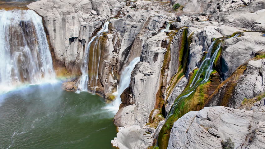 Panning view of a rainbow in front of Shoshone Falls in Twin Falls, Idaho.