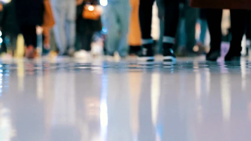 Blurred Motion of People Walking in a Public Space, Low Angle View