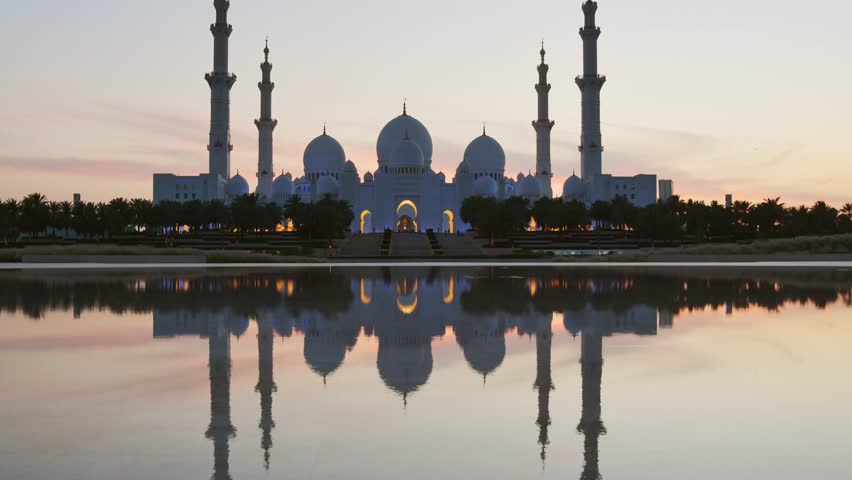 Time lapse panorama Sheikh Zayed Bin Sultan Al Nahyan Mosque, Abu Dhabi, United Arab Emirates, UAE. Beautiful hidden gem viewpoint with reflections of Grand mosque and traffic at dawn