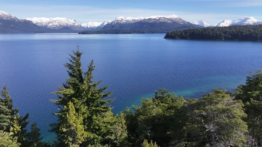Patagonia Skyline In Villa La Angostura Neuquen Argentina. Aerial View Of A River Surrounded By Lush Green Tropical Rainforest. Snowflakes Lake Glacial Snow Mountain. Snowflakes Nature.