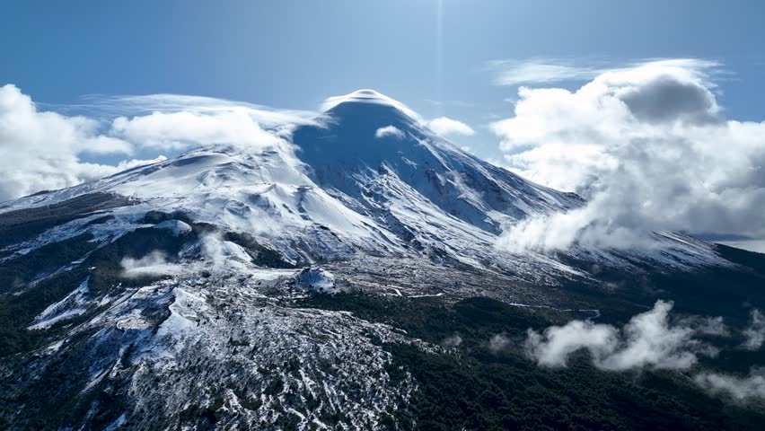 Osorno Volcano In Osorno Los Lagos Chile. Snow-Capped Volcano Releasing Plumes Of Smoke Into Blue Sky. Snowflakes Lake Glacial Snow Mountain. Snowflakes Nature. Osorno Los Lagos.