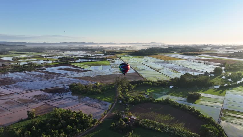 Colorful Balloon In Praia Grande Santa Catarina Brazil. Bright Colorful Hot Air Balloon Is Floating Over A Green Countryside. Sunset Road Mound Beautiful. Road Forest. Praia Grande Santa Catarina.