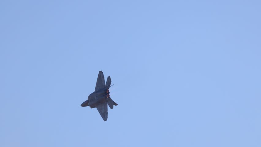 Geelong, Victoria, Australia - 28 March, 2025: F-22 Raptor performs dynamic maneuvers against a clear blue sky at the Avalon Airshow in Geelong, Australia