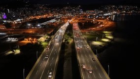 Night Skyline In Florianopolis Santa Catarina Brazil. Aerial View Of Landmark Bridge Showcasing Its Intricate Design . Building Clouds Sky Downtown Cityscape. Night Outdoors Panning Wide. - Powered by Shutterstock - Get 15% off with code: PIKWIZARD15
